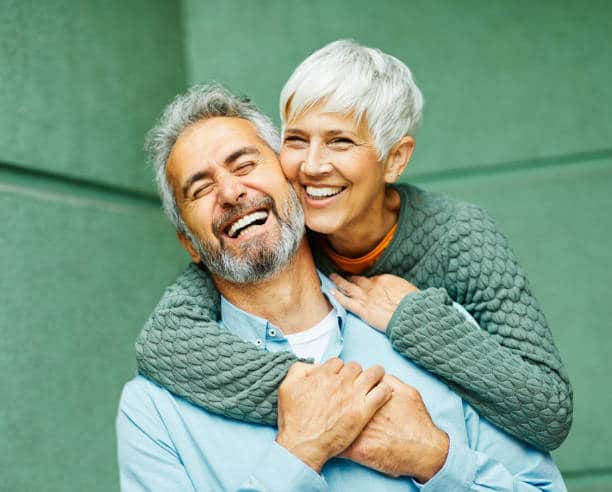 Happy couple with dental implants