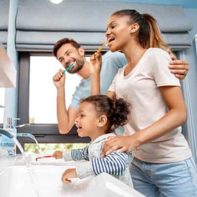 Family brushing their teeth
